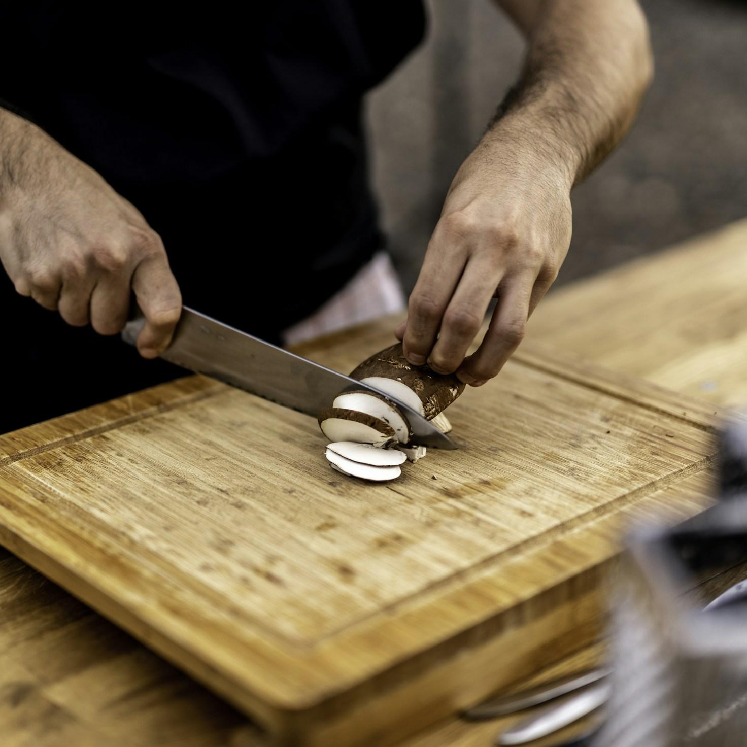 Community members collaborating in a contemporary kitchen, sharing recipes and techniques